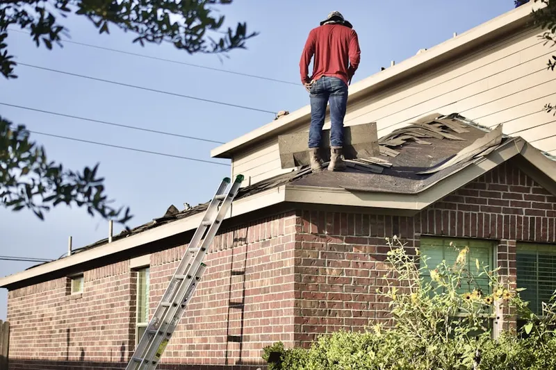 Professional roofer working on a residential roof in Crestwood